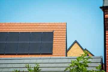 solar panels on roof of new houses in england uk on bright sunny day