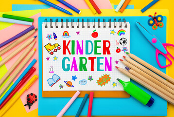Childish lettering Kindergarten, notebook or scrapbook. Top view flat lay concept. Colored paper, multi-coloured letters, supplies, stationery for Pre-school, nursery school, preschool educational