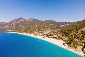 Aerial wide shot of Oludeniz resort village on Aegean sea coast in Turkey, with copy space