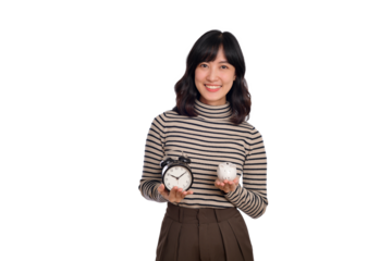 Happy Asian woman with sweater shirt holding alarm clock and piggy bank isolated on white background - PNG format