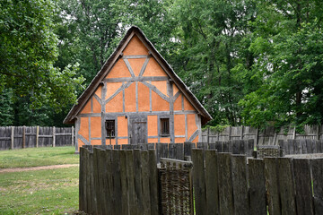 Orange house with wooden fence, Early Settlement Interpretive, Henricus Historical Park, Chester, Virginia