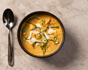 Coconut Curry Dish in a Black Bowl on a Marble Counter 