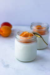 Homemade yogurt with juicy apricots. Yogurt on a white table