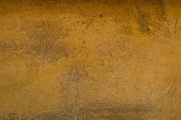 Yellow ochre colored sand-faced plaster finish wall texture