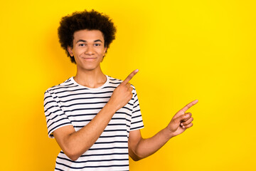 Portrait of young promoter student guy wear trendy t-shirt recommend business school point fingers...