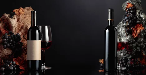  Bottles and glasses of red wine on a black background. © Igor Normann