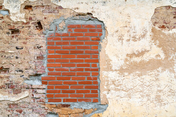 Fototapeta na wymiar Aged brick wall with a bricked up window with space for text