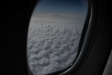 The sky and clouds from an airplane window. The beauty of the sky from high above, the airplane wing.