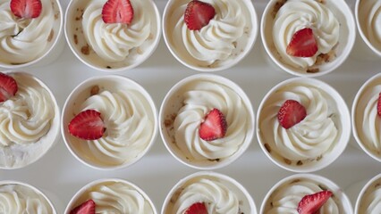 Dessert cups, whipped cream strawberries nut pieces