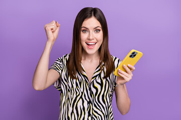 Photo of young girl fun fist up hold phone wear zebra retro print shirt hold phone victory bet profit isolated on violet color background