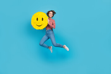 Full length photo of charming pretty woman dressed print top jumping high rising smiley pinata empty space isolated blue color background