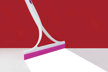 floor squeegee on red background bottom white There are traces of cleaning, bright white.