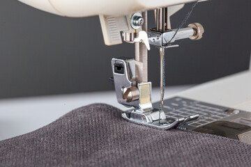 Sewing machine, stitching fabrics, needle in a round plan