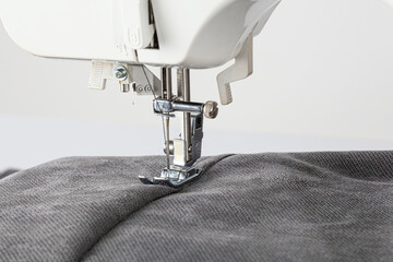 Sewing machine, stitching fabrics, needle in a round plan