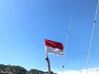 Indonesia national flag fluttering. The flag blowing in beautiful soft sky. Indonesia national flag for independence day.