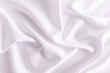 Delicate texture of white satin fabric with soft waves. Elegant white wedding background. layout for design.