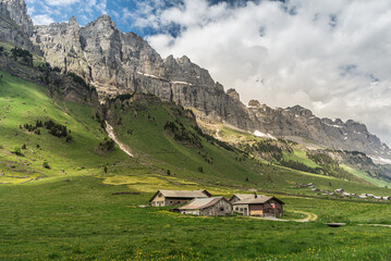 Fototapeta na wymiar Alpine huts and barns on Urnerboden, the largest alp in Switzerland at the foot of the Glarus Alps near Klausenpass, Spiringen, Canton Uri, Switzerland