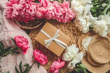 Gift box with bow and pink peonies, holiday concept