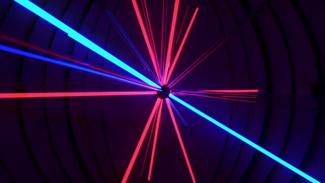 Neon Tubes Sun array, laser like light tubes, spinning and glowing in red and blue colors, seamless VJ Loop