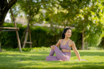 Naklejka na ściany i meble Asian woman wearing yoga clothes doing yoga at her village garden in the morning, happily, Sports healthy lifestyle concepts, Japanese concepts.