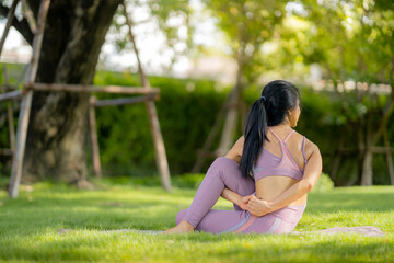 Asian woman wearing yoga clothes doing yoga at her village garden in the morning, happily, Sports healthy lifestyle concepts, Japanese concepts.