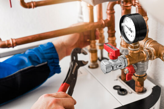 Plumbing concept or service worker. Copper pipelines close up with analog watch pressure water.