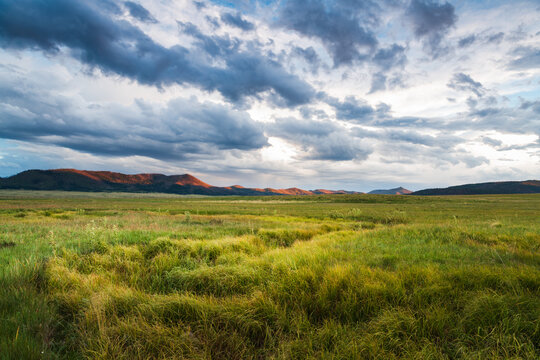 A grassy meadow and clouds in the Valles Caldera National Preserve, New Mexico