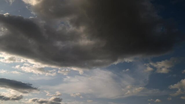 Illuminated sky at sunset with a moving storm cloud