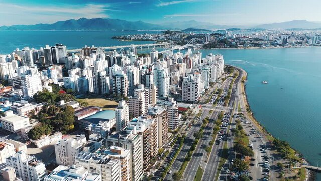 Aerial view of the city of Florianopolis and its coastal highway during sunny day. Santa Catarina state in Brazil