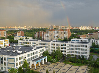 Rainbow, rain and sun over Moscow city. Russia