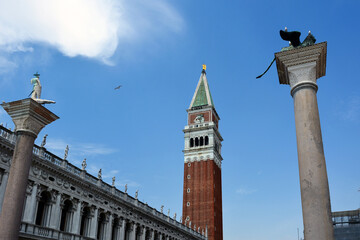 Fototapeta na wymiar San Marco Bell Tower and nearby historical landmarks in Venice, Italy. View from below