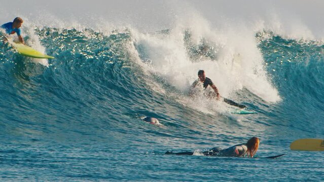 Male surfer takes off but falls right onto his own surf board and then into the water
