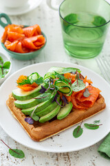 smoked salmon, avocado and cucumber waffle sandwich
