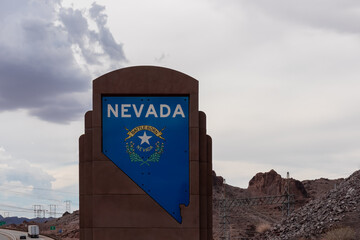 Sign at the Nevada Arizona state line at Hoover Dam in the Black Canyon of the Colorado River near...