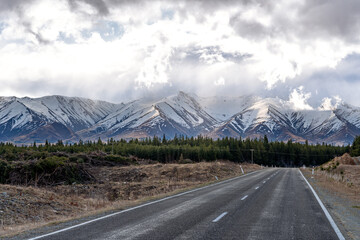 A scenic landscape of road to Aoraki Mount Cook - Lake Pukaki with blue sky and clouds, South...