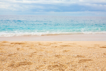 Fototapeta na wymiar Empty sandy beach. Mediterranean sea coast. Summer background of sand, copy space. Selective focus. 
