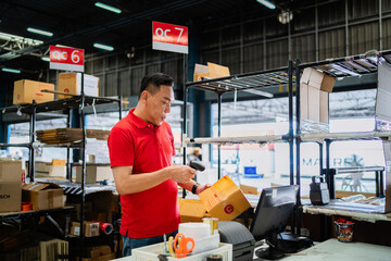 Fototapeta premium Portrait of a warehouse worker scanning cargo boxes in a large warehouse. Logistics distribution warehouse concept.