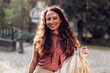 outdoors portrait of elegant hispanic smiling businesswoman