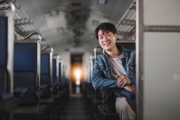 Asian man traveler with backpack in the railway, Backpack at the train station with a traveler. Travel concept. Man traveler tourist walking at train station.