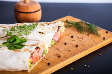 Delicious kebab with meat, lettuce, tomato, onion and sauce with french fries.