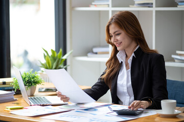 Successful happy smiling businesswoman saleswoman working on laptop computer, Young female making...