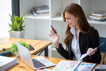 Successful happy smiling businesswoman saleswoman working on laptop computer, Young female making...