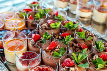 Delicious Chocolate Desserts With Strawberries and Mint in Glasses on a Table Buffet