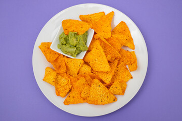 plate of corn chips nachos with guacamole on plate