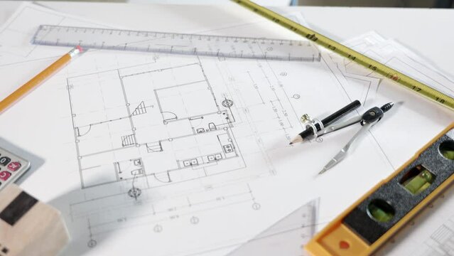 Architectural project workplace. Top view of house plan blueprint paper with repair tools on table desk at architecture office, Engineering architect design tools concept