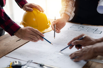 The home design architects are reviewing the house plan draft, the project commissioned by the client, and the custom design before delivery. Interior design and decoration ideas.