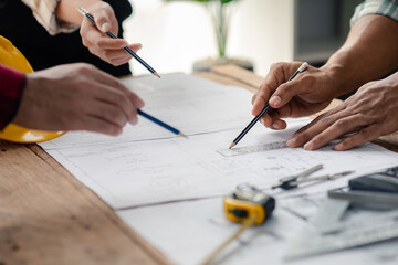 The home design architects are reviewing the house plan draft, the project commissioned by the client, and the custom design before delivery. Interior design and decoration ideas.