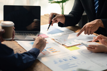 Group businessmen point to the material for the meeting, working together to plan to develop and solve common business problems. Concept of business management for growth and quality.