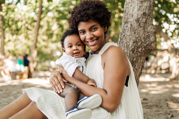 A proud mother with her new born baby boy in the beach.