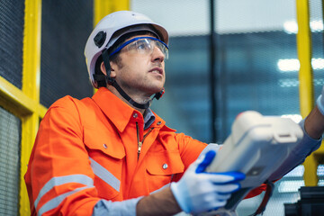 Engineers team mechanic using computer controller Robotic arm for welding steel in steel factory...